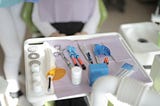 dental equipment on a tray in front of a patient sitting in the exam chair