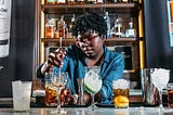 A bartender mixing drinks.