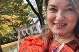 The author walking on a beautiful autumn day while appreciating the beauty of coral roses.