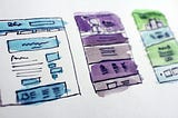 Hand-drawn wireframes watercolored in blue, purple, and green