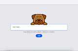 Tater is a brown bulldog hovering above a text input bar prompting the user the ‘Ask Tater’. The background is gray, and the Ask button is blue.