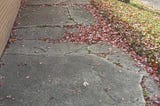 Broken, uneven sidewalk on 110th Street and St. Louis Avenue