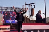 Musk jumping up and down at a Trump rally