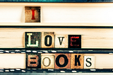 Blocks spelling out “I Love Books” in front of a stack of books