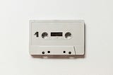 A blank, white cassette, symbolic of a clean slate, a fresh start