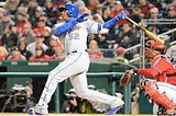 New York player swinging bat at the plate.