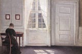 A painting of a woman sat at a desk next to a window, sunlight falls into the room and across the floor beside her. Painted by Vilhelm Hammershøi