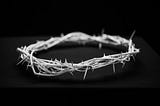 A crown of barbed wire on a black background