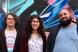 Three of the fired Google organizers standing against a colorful backdrop.