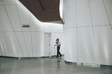 a man sweeping a corridor. a creative in action