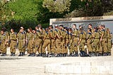 IDF soldiers standing in an open area with trees