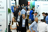 A photograph of visitors walking between stands at Connect In Pharma trade show