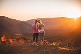 Two women hugging on a hike