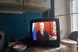 Vladimir Putin, President of Russia, is seen on TV as he addresses Russian citizens about PMC Wagner in June 2023.