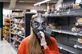 Hardware store employee trying on gasmask.