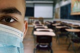 Student in classroom wearing a face mask.