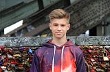 young man standing in front of graffiti