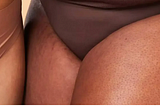 The lower regions of four women of different ethnicities wearing underwear.
