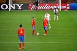 Iniesta and Xavi about to take kick off in a football match between Spain and Portugal