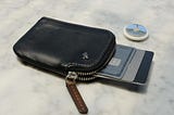 Black Bellroy Card Pocket with cards sticking out