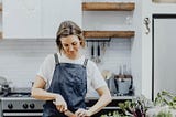 woman cutting vegetables in a commercial kitchen