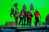 The cast of The Bubble running on a treadmill in front of a green screen
