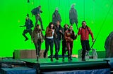 The cast of The Bubble running on a treadmill in front of a green screen