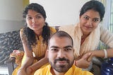 This image is of myself and my sisters sitting together after a family function. Our attire is mostly yellow with a sweet smile on everyone’s face. I am lucky to have them. This is a selfie taken in 2024. — alt text to boost Medium stories.