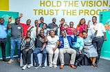 A group of Ugandan adults pose happily for the camera