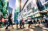 Image of people walking across a busy city street