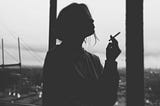 Silhouette Of Woman Smoking Cigarette