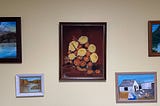 a white wall with framed art displayed