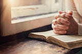 Hands clasped in prayer