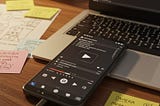 An android phone and a laptop with code on the screen