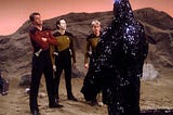 Three members of the Star Trek Enterprise away team confront the Skin Of Evil