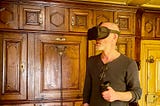 Young man with Oculus headset in a wooden parlor