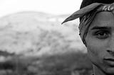 Black and white photo of half of a mans face wearing a bandana