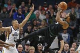 T-Wolves’ Derrick Rose attempting a shot over Dante Exum of the Jazz, via Jim Mone — Associated Press