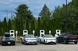 Four electric vehicles charging simultaneously at Electrify America station in Maine