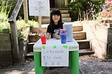 A young girl with a lemonade stand