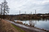 A cyclist rides on the muddy river path. Essen, Germany, February 29, 2024.