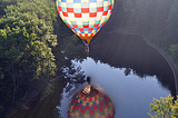 Hot-air balloon reflected in a river near Hillsborough, New Hampshire, USA
