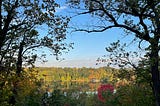 A view of the Mississippi River on a glassy September morning. You can see the leaves starting to change.