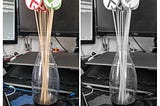 A pair of photos of the finished sticks. The sticks are about 30cm longs and are collected together in a glass bottle. All of the sticks have a white circle at the top, half of them contain a red cross and the other half contain a green tick. The picture on the left shows the sticks in colour and the picture on the right shows them in black and white.