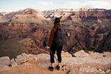 A woman with hiking poles looking out at the Grand Canyon. You alone can know who you are.