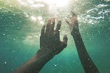 Two hands underwater