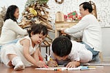 Young children colouring and enjoying Holiday activities for the whole family.