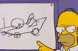 A screenshot from a Simpsons episode that shows Homer Simpson pointing at a drawing of car that he has made (it looks like its been drawn by a child)