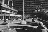 sitting on the lakeside terrace bench of the barbican