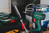 Tools resting and not in use, yet. Hammer, drill, paint can.